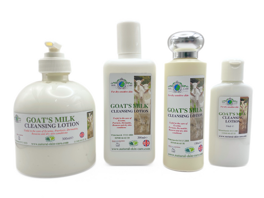Four bottles of goat's milk cleansing lotion on a white background